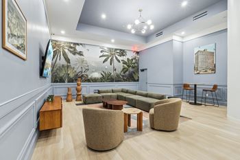 A living room with a couch, chairs, and a coffee table. at LiveWell Apartments, Pittsburgh, PA, 15222